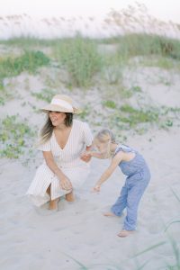 mom plays with daughter on the beach during Sullivans Island family session