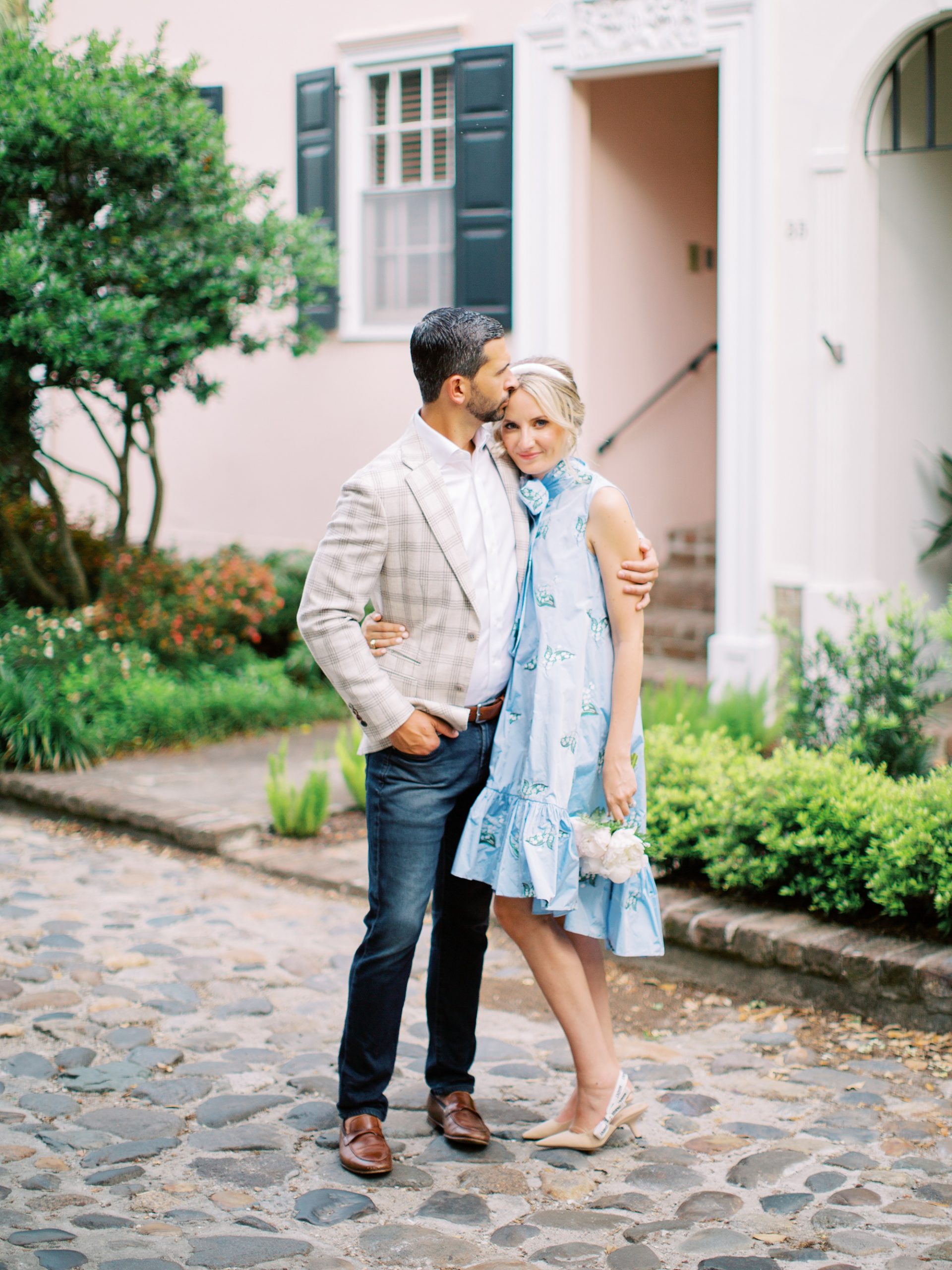 husband kisses wife's forehead during Charleston wedding photos