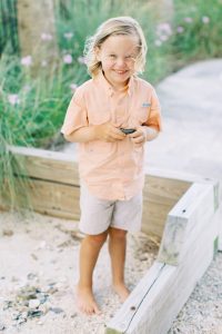 boy plays in sand during Charleston family session