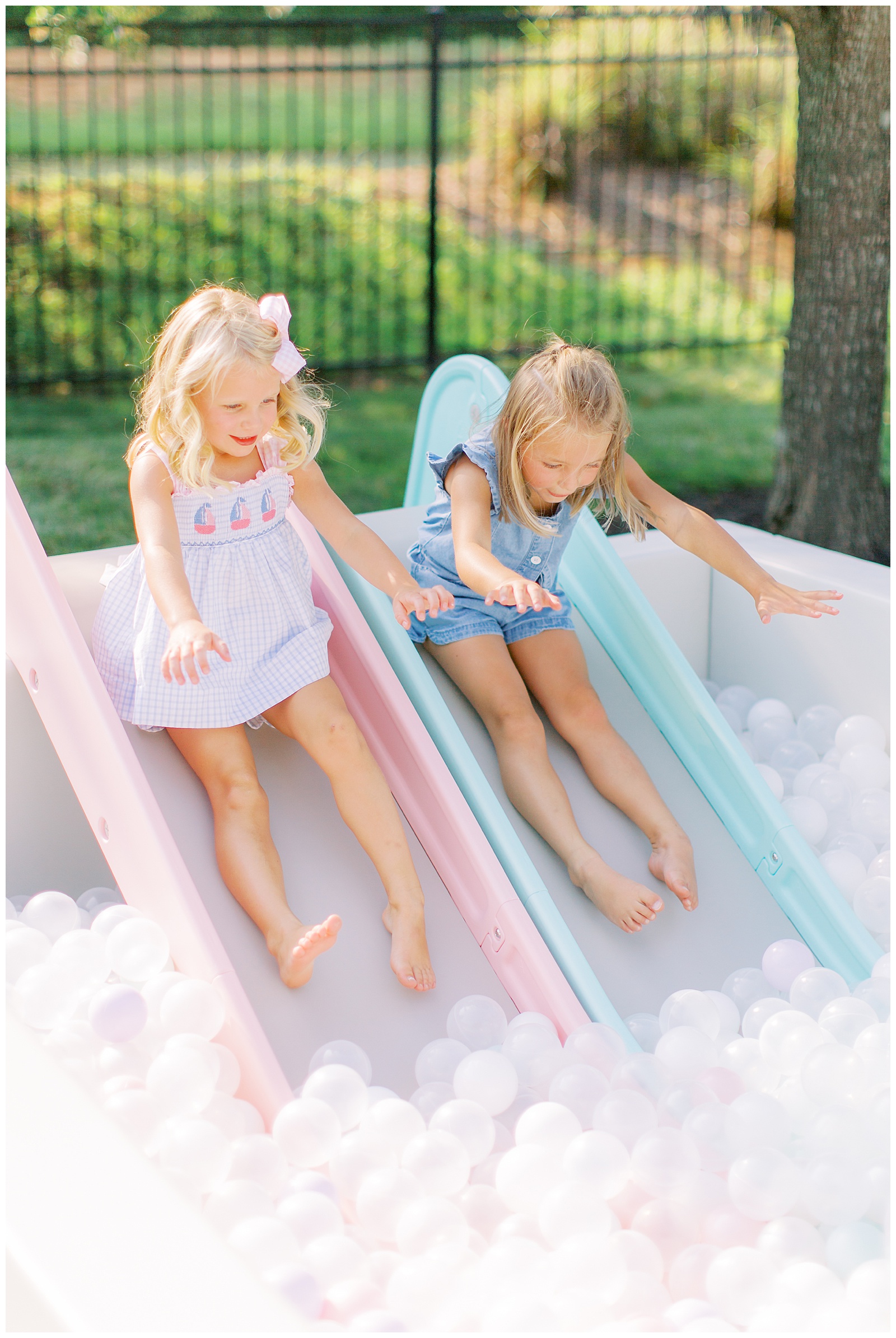 girls enjoying the slides and ball pit at a kids birthday party in Charlotte, NC