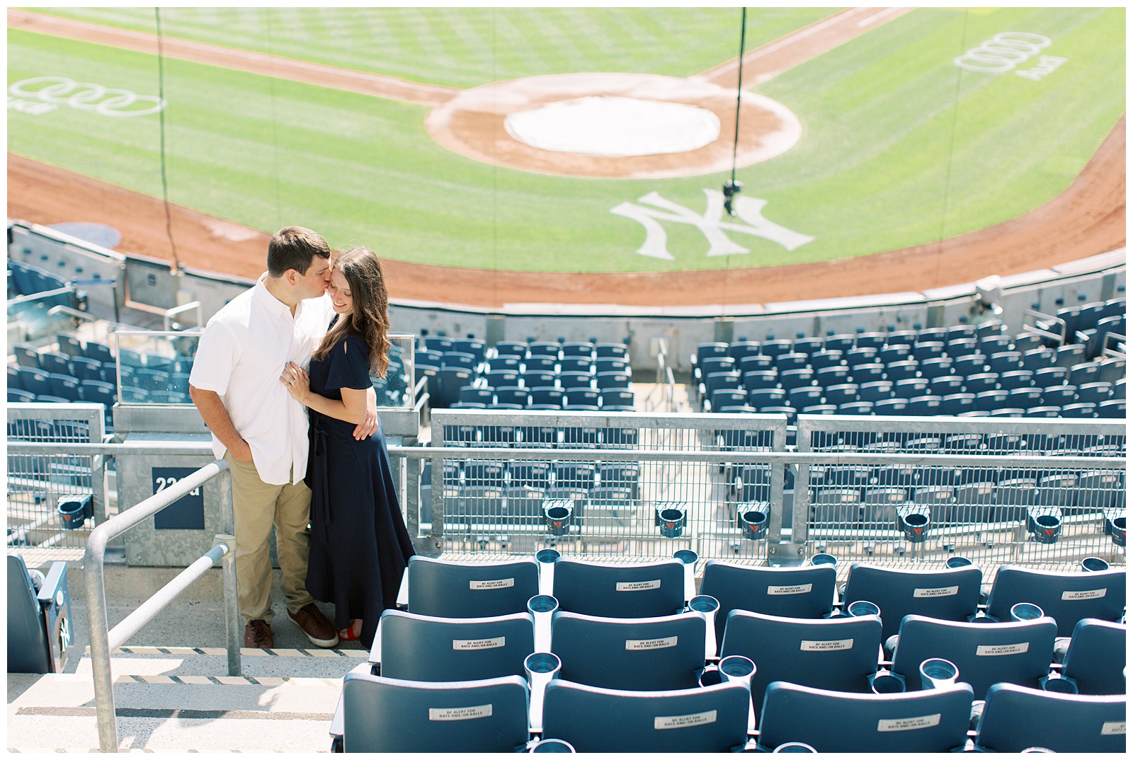 bride and groom stand together in seats at Monument Park 