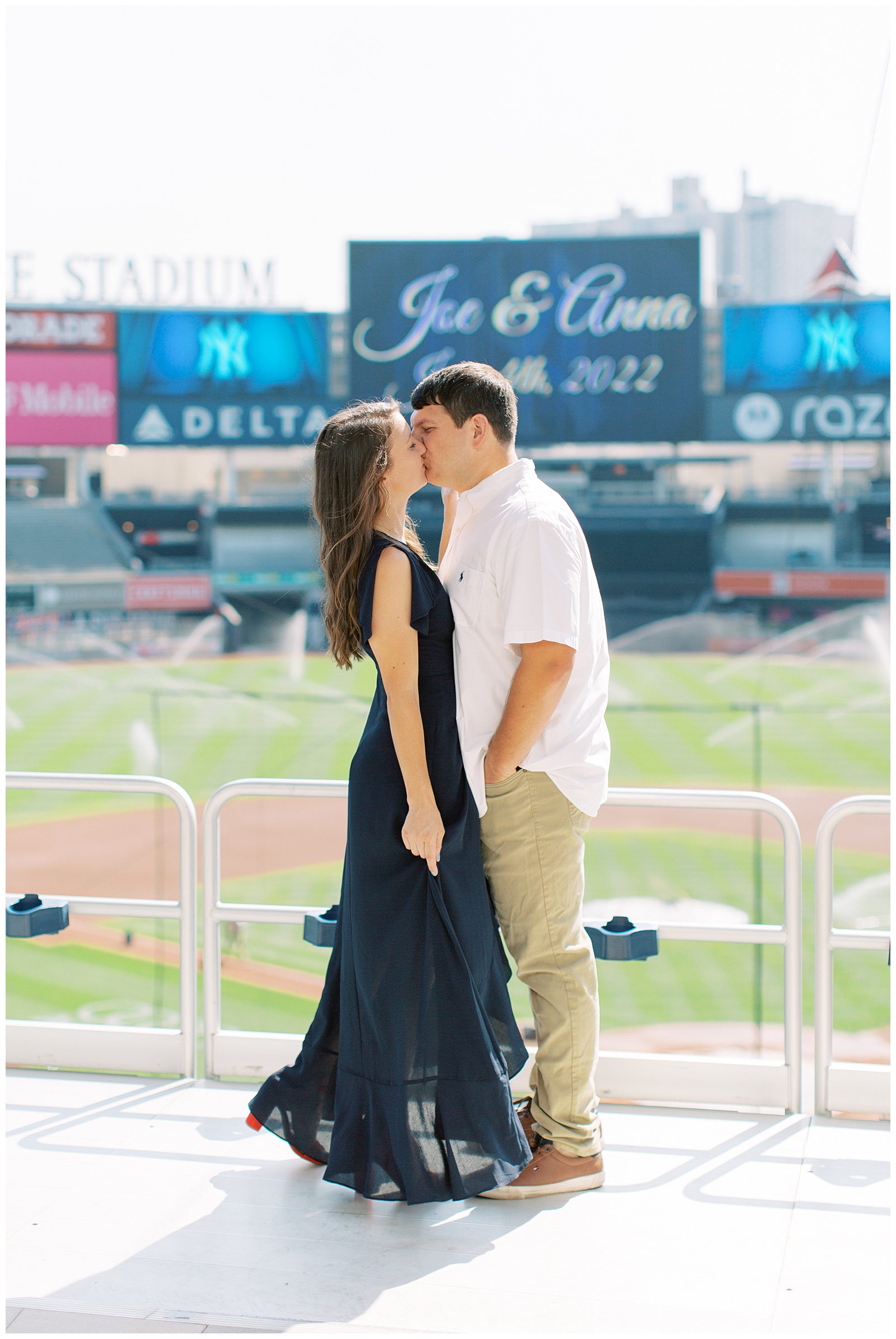 bride and groom kiss in front of signs at Monument Park 