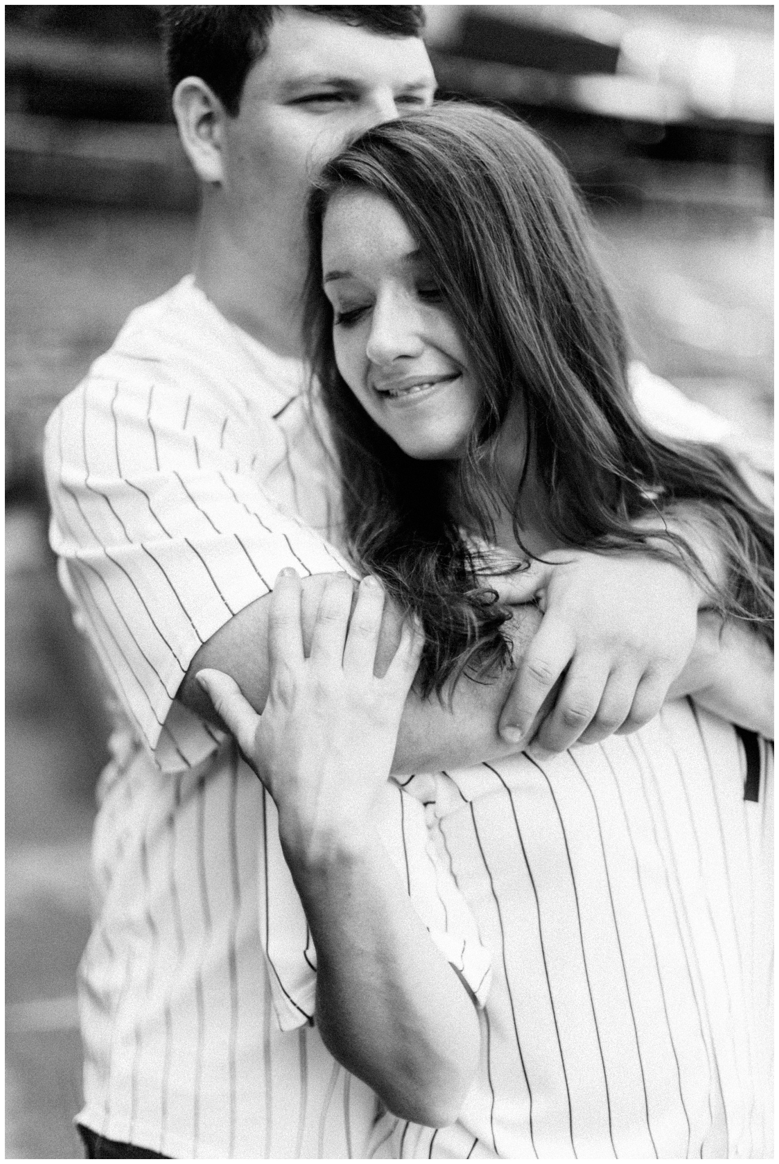 engaged couple hugs in Monument Park during Yankee Stadium Engagement Session