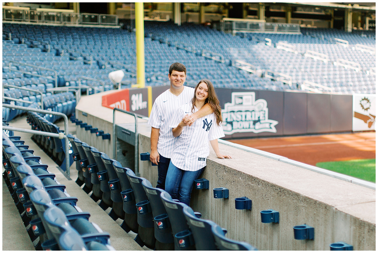 bride and groom pose together in Monument Park during Yankee Stadium Engagement Session