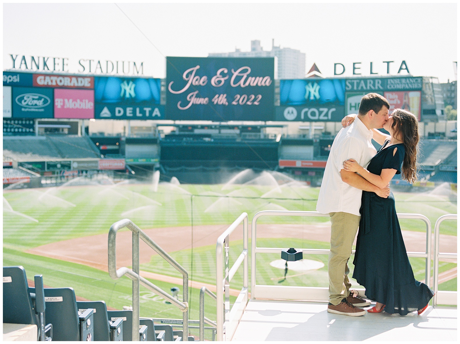 engaged couple poses in stands during Yankee Stadium Engagement Session