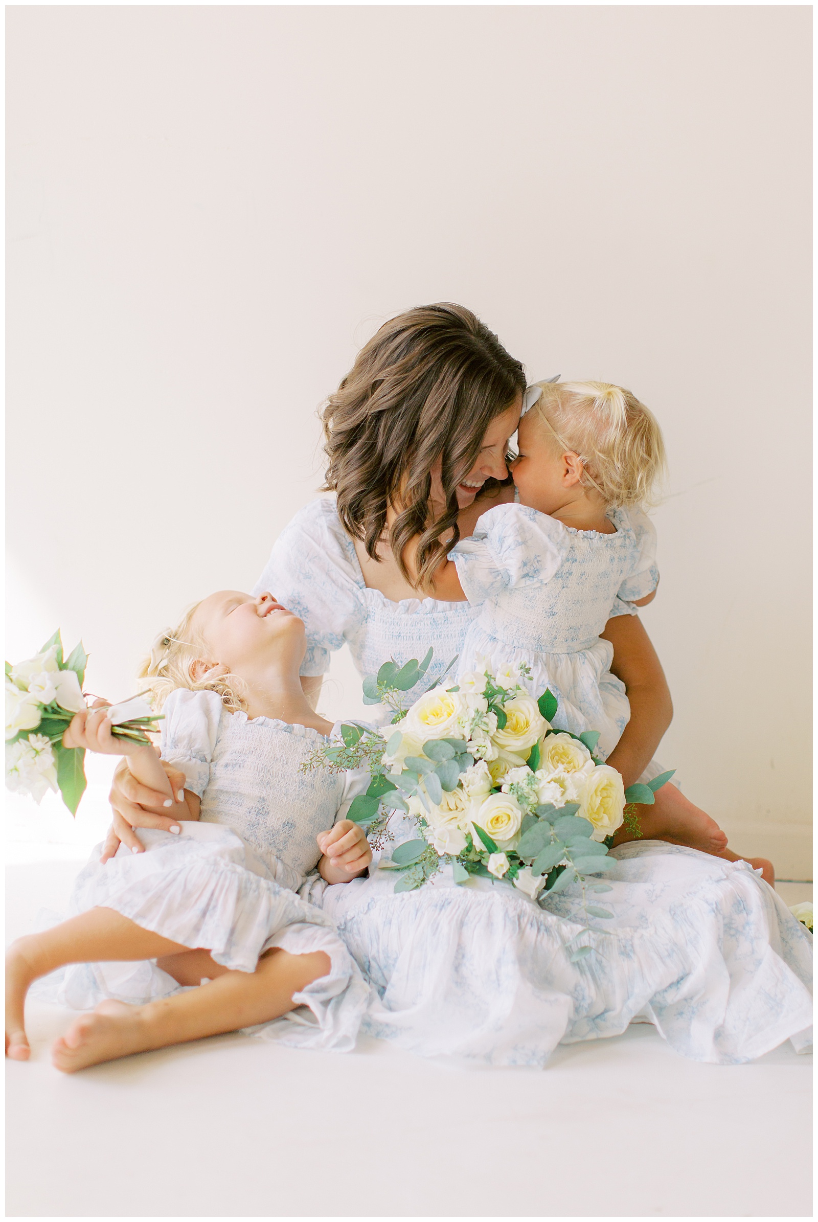 mom holds two daughters during branding photos