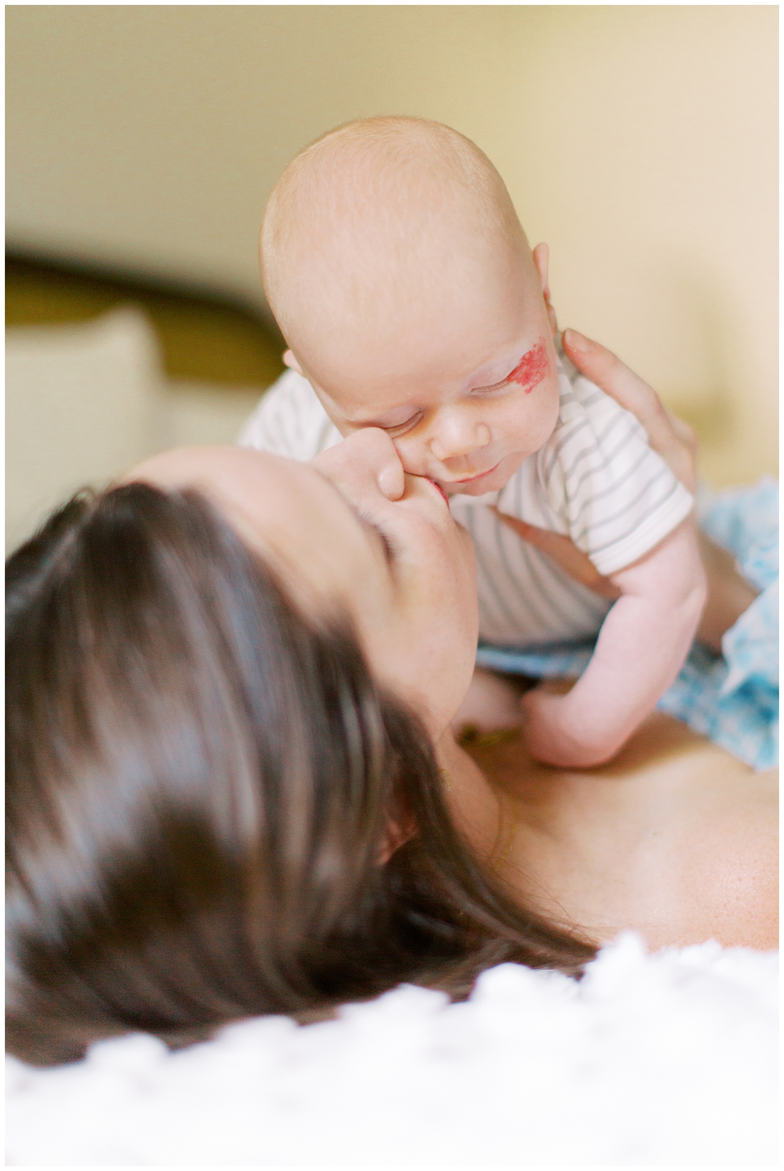 mom kisses son during lifestyle newborn photos at home