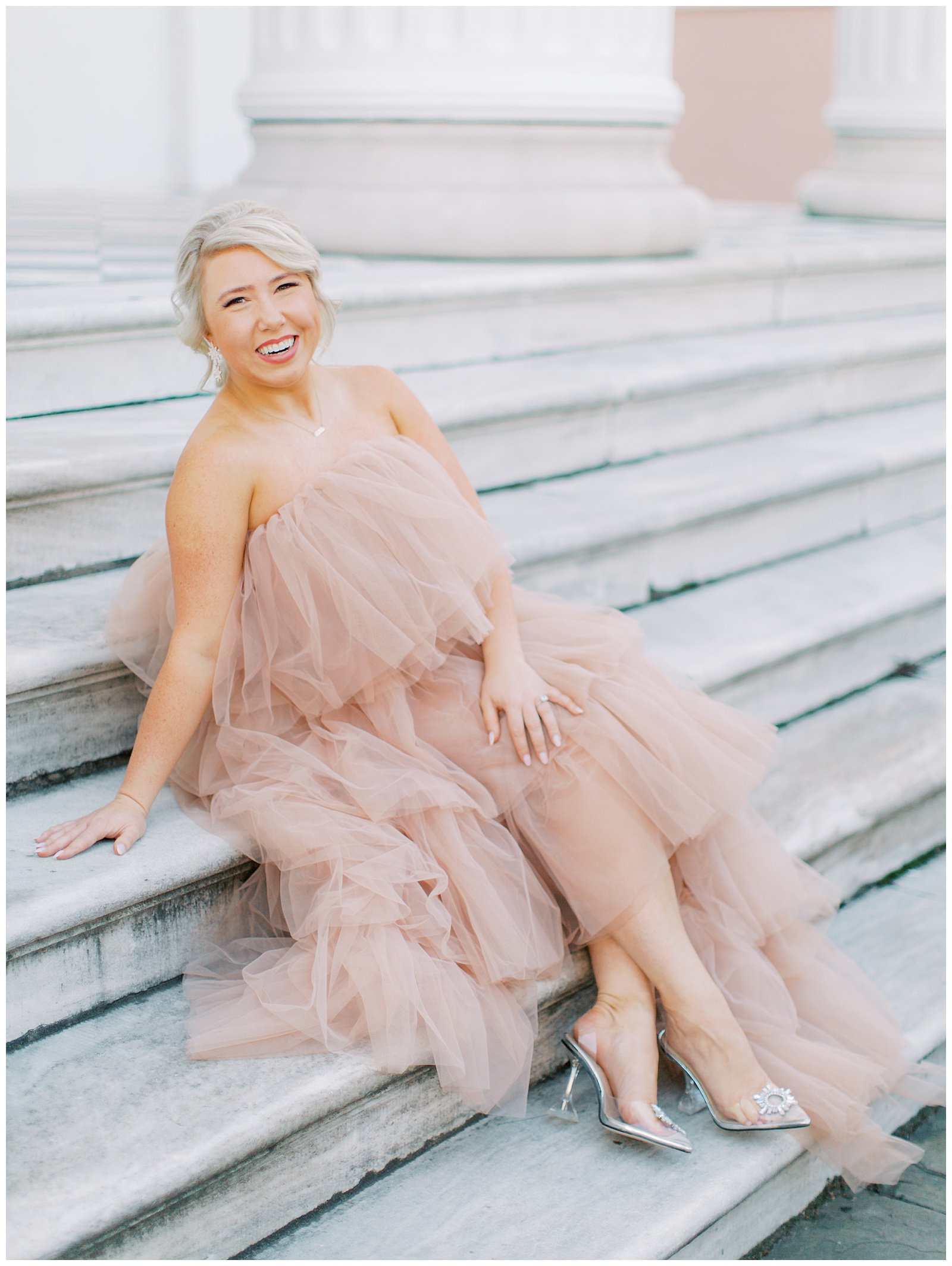 bride sits on steps in statement dress from Untamed Petals