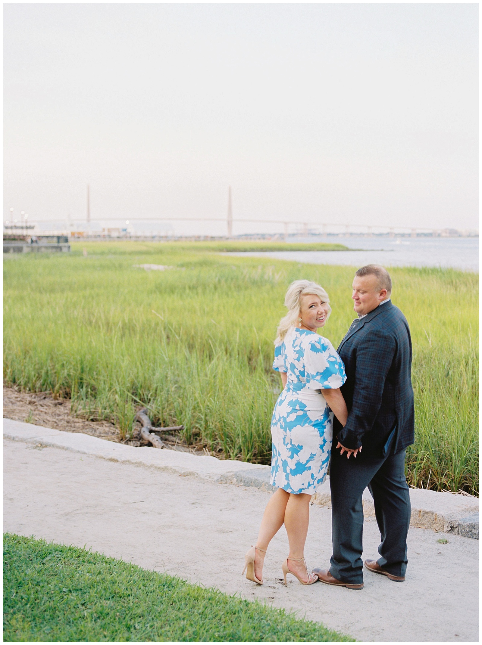 couple walks along waterfront in Charleston SC