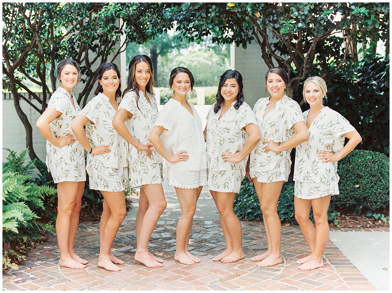 bride and bridesmaids pose in matching pjs during Charlotte NC wedding day prep