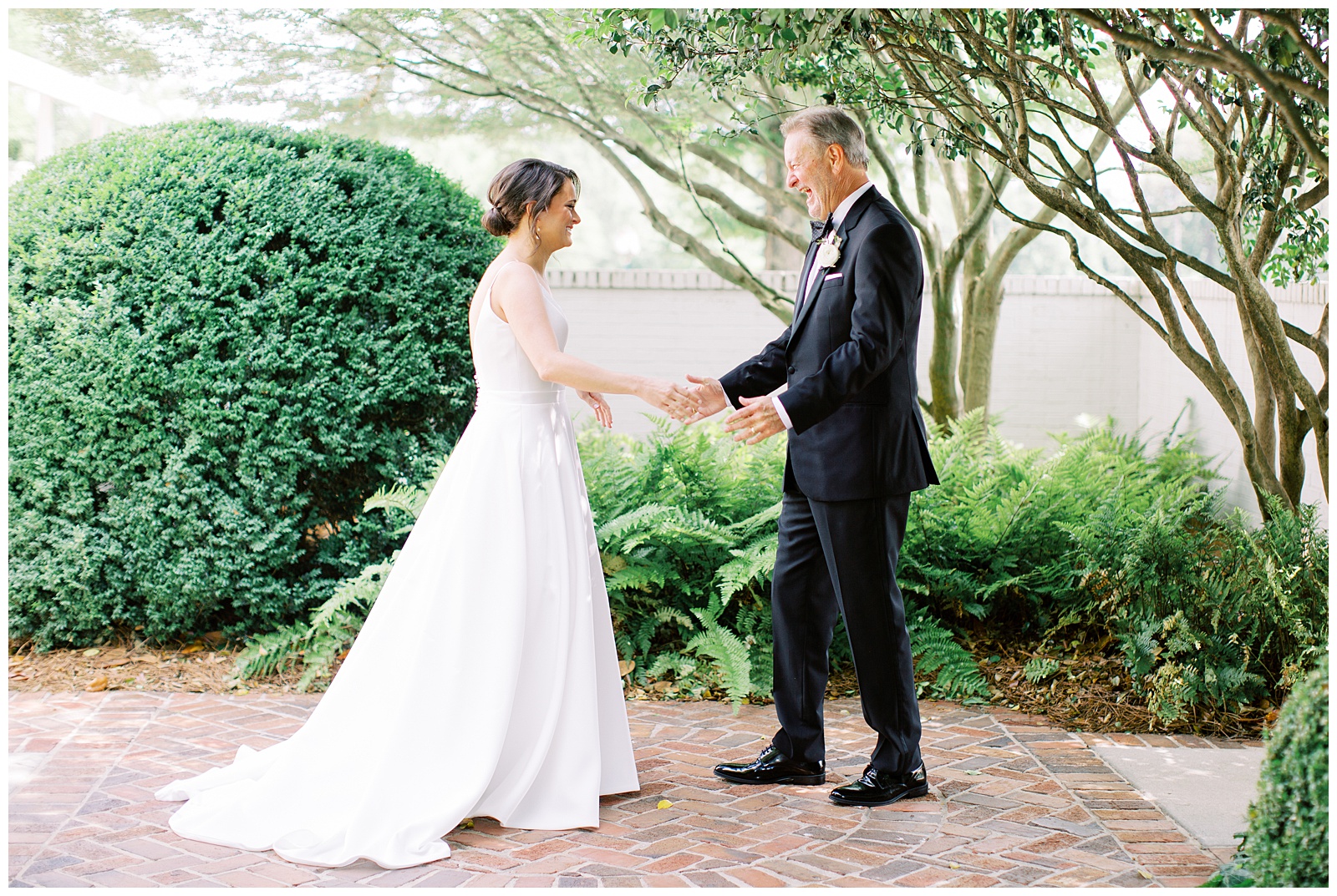 bride and dad laugh during first look in Charlotte NC