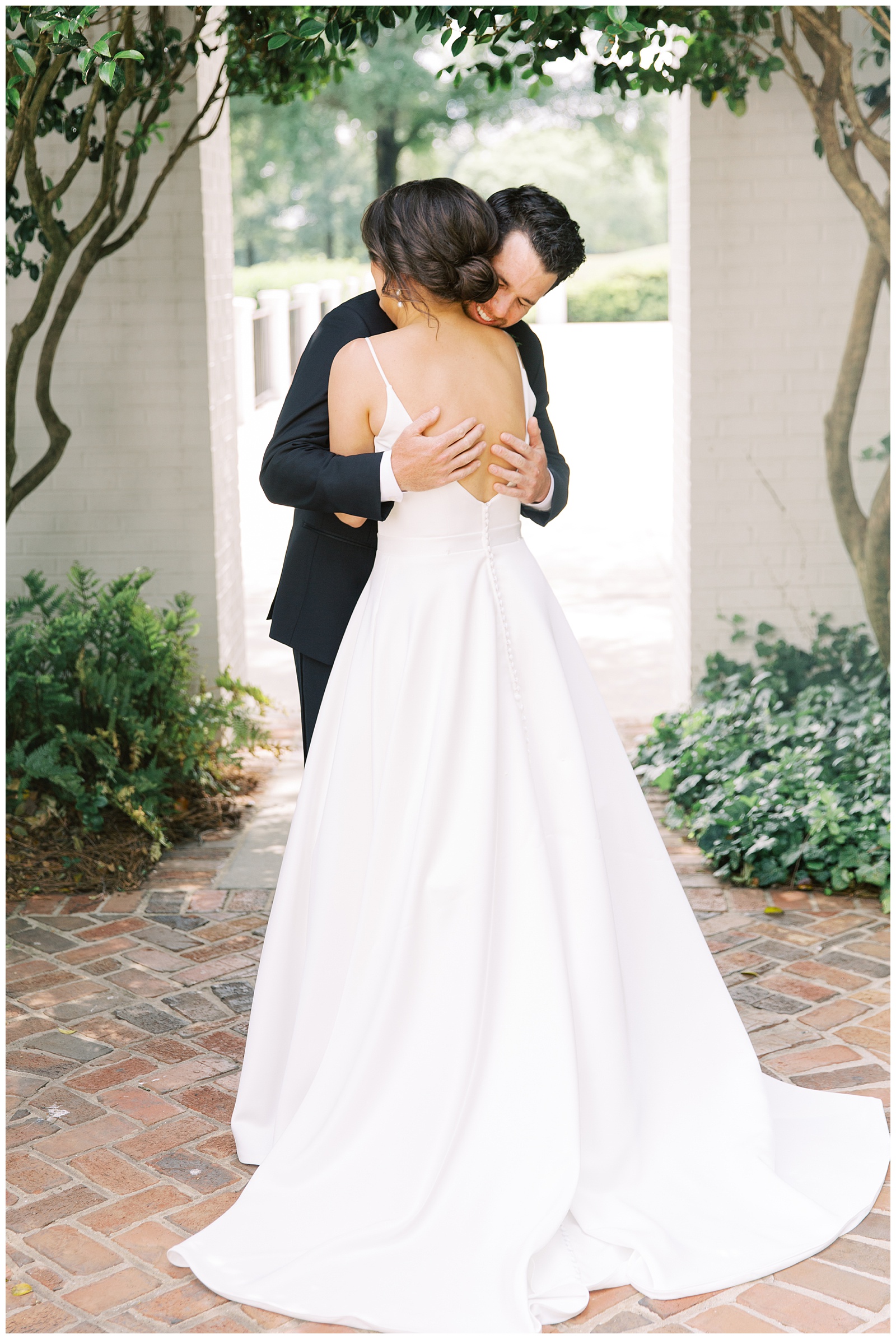 bride and groom hug during first look at Quail Hollow Country Club