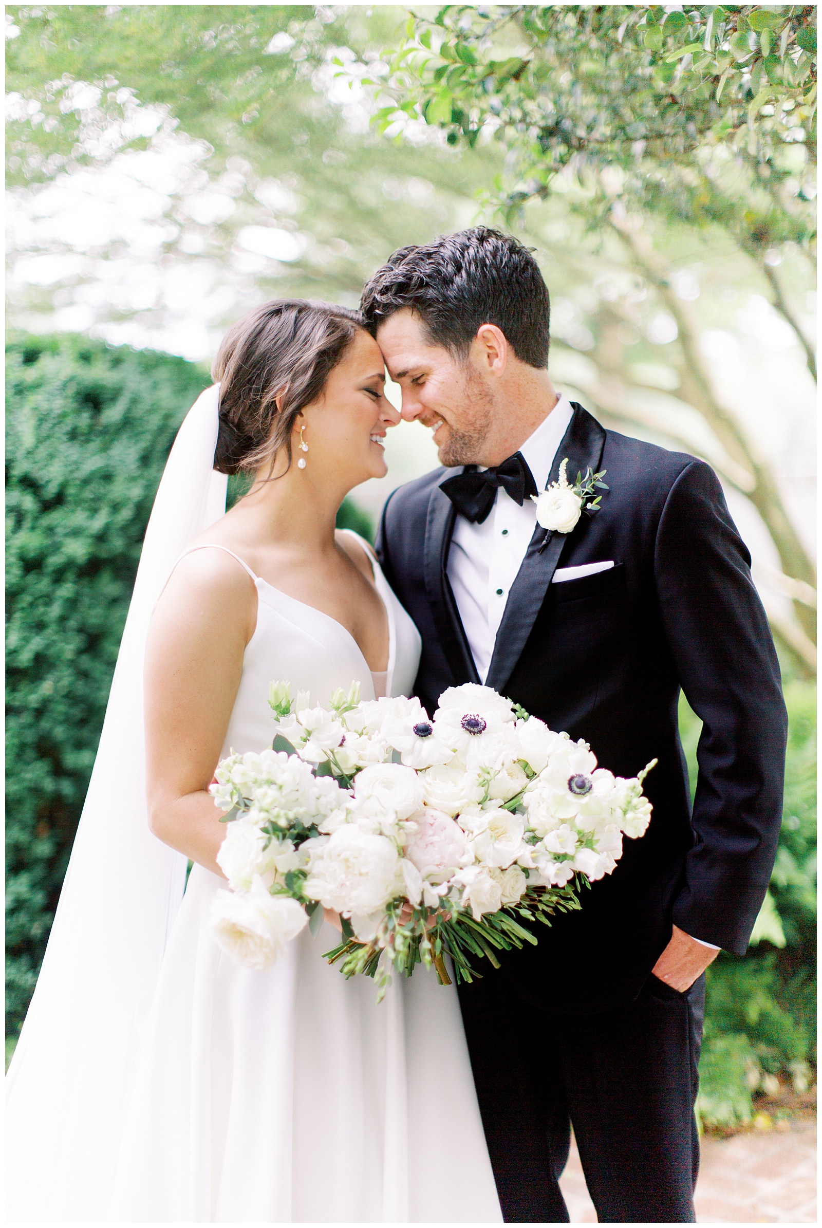 bride and groom stand together touching noses at Quail Hollow Country Club