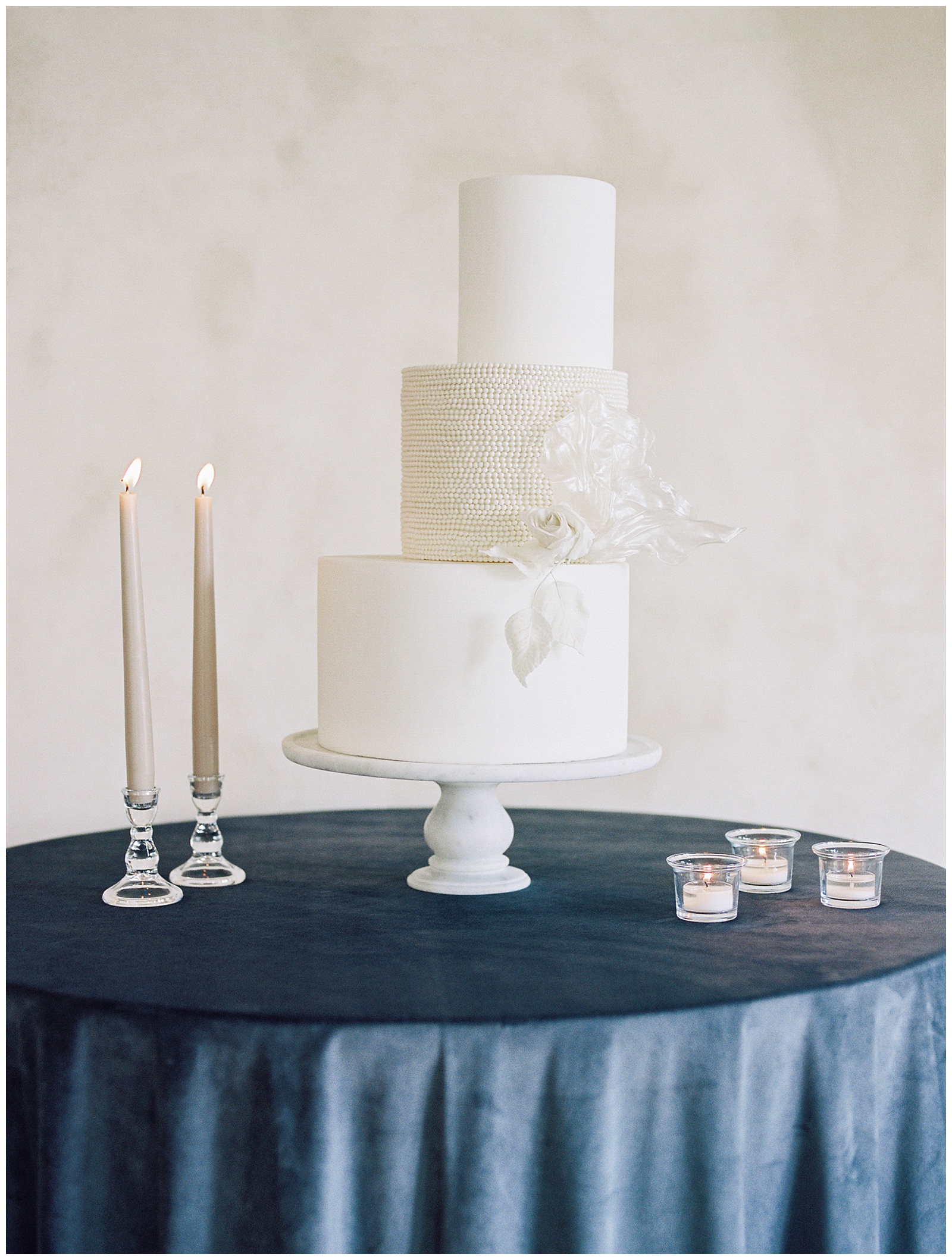 off center tiered wedding cake with pearl middle level at River Bottoms Ranch wedding