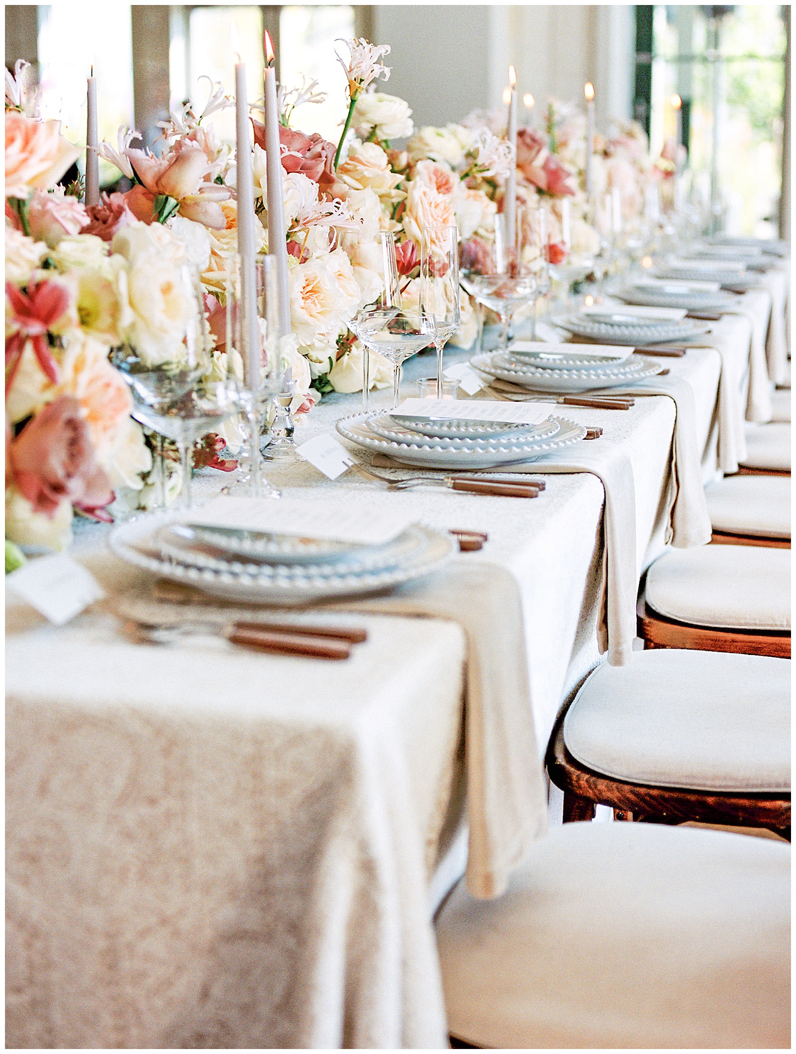 wedding reception with scalloped edge plates and family style table