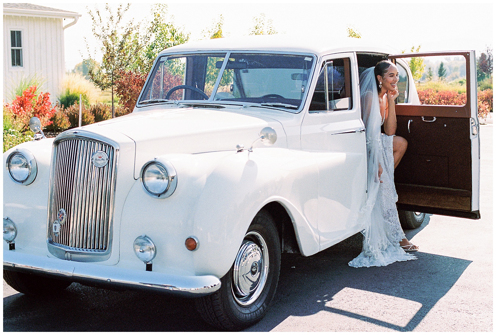 bride poses in Rolls Royce outside River Bottoms Ranch