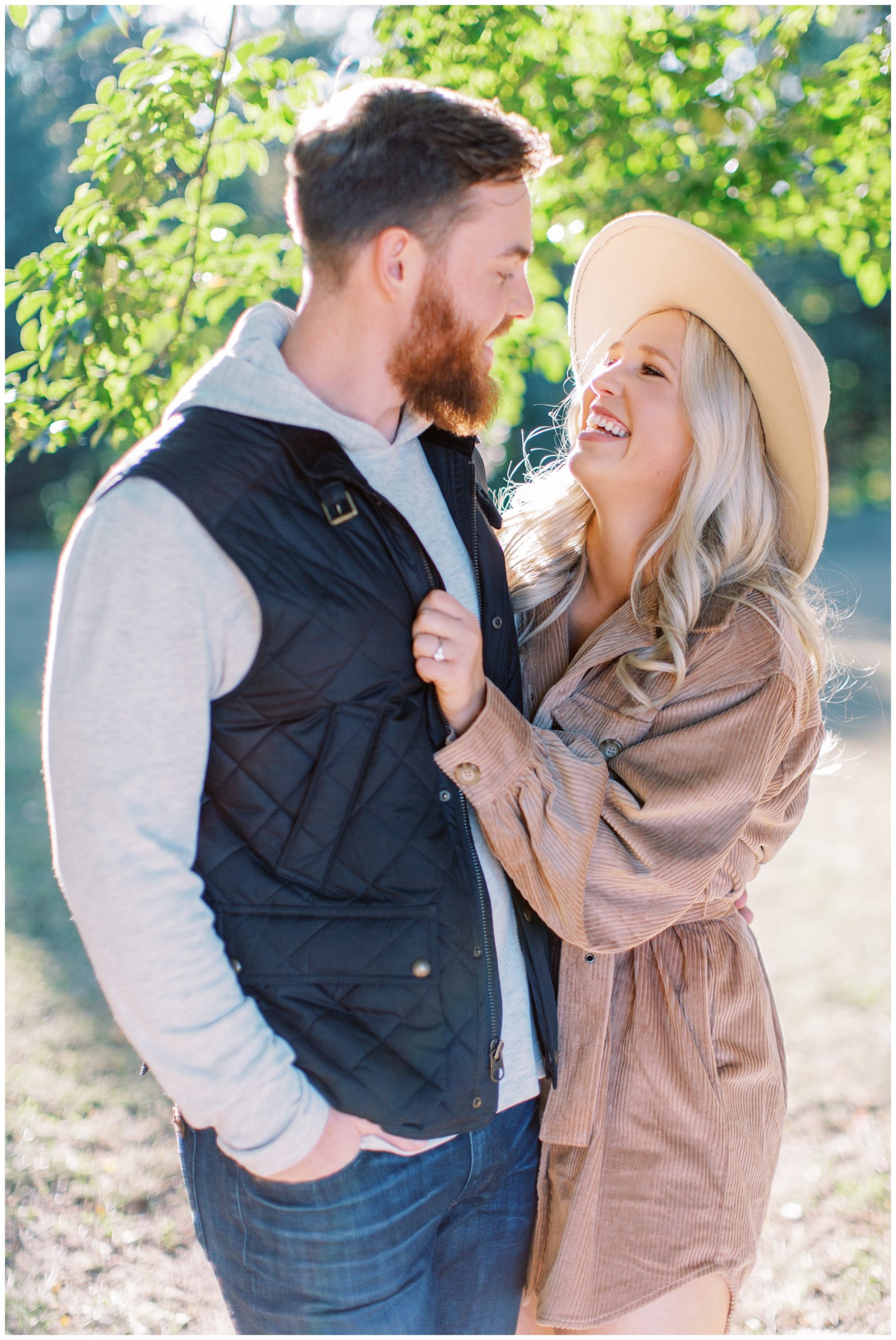 engaged couple laughs together during Ronda NC engagement portraits 
