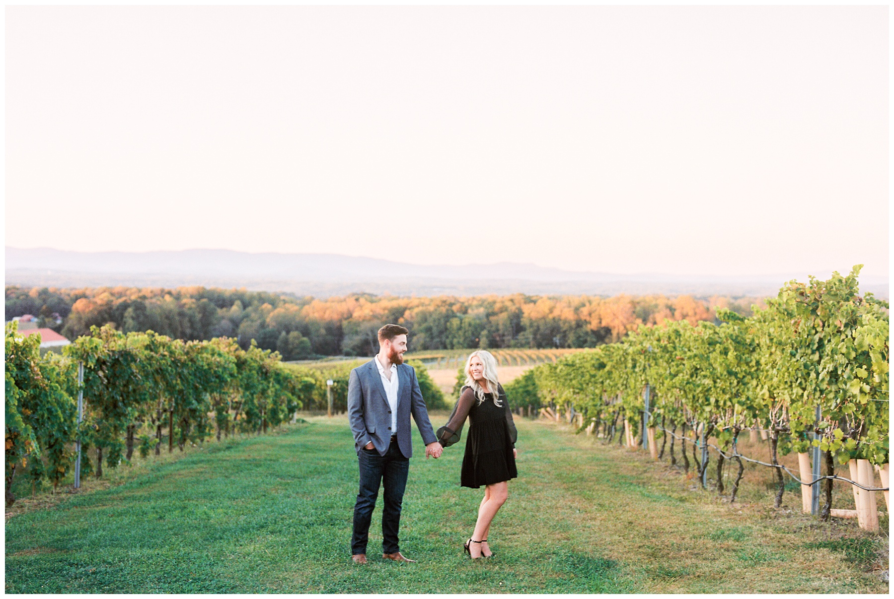 bride and groom hold hands standing in row of vines at Raffaldini Vineyards