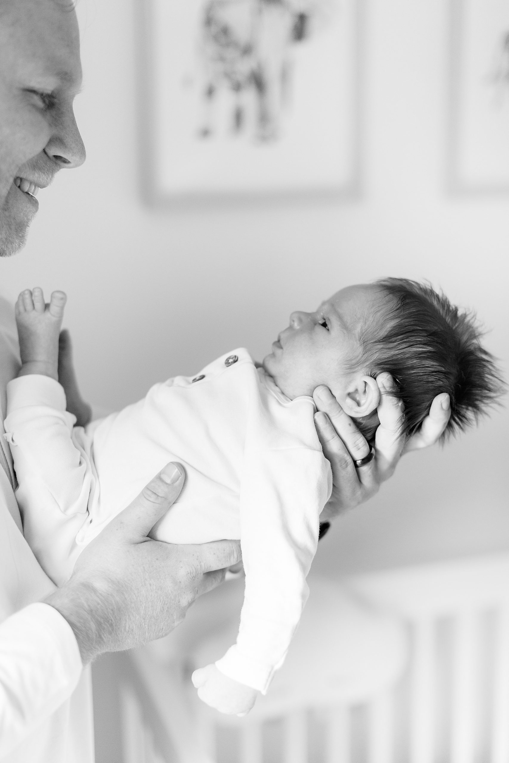 dad looks at son during Charlotte newborn session
