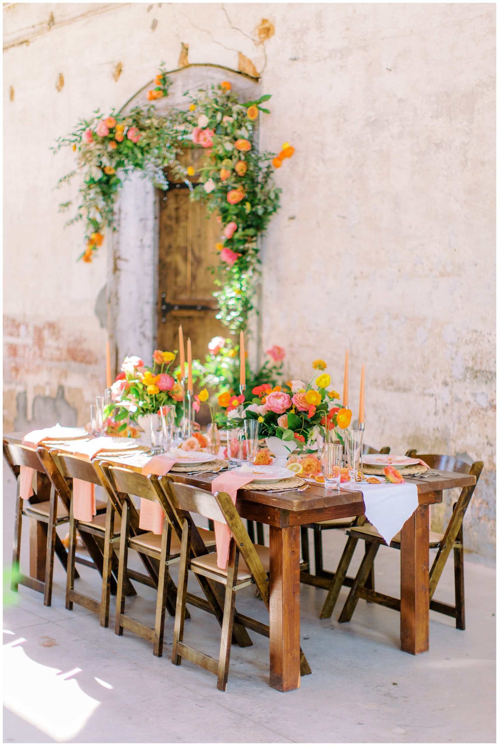 tables cape with orange, pink, and yellow for citrus inspired wedding reception 