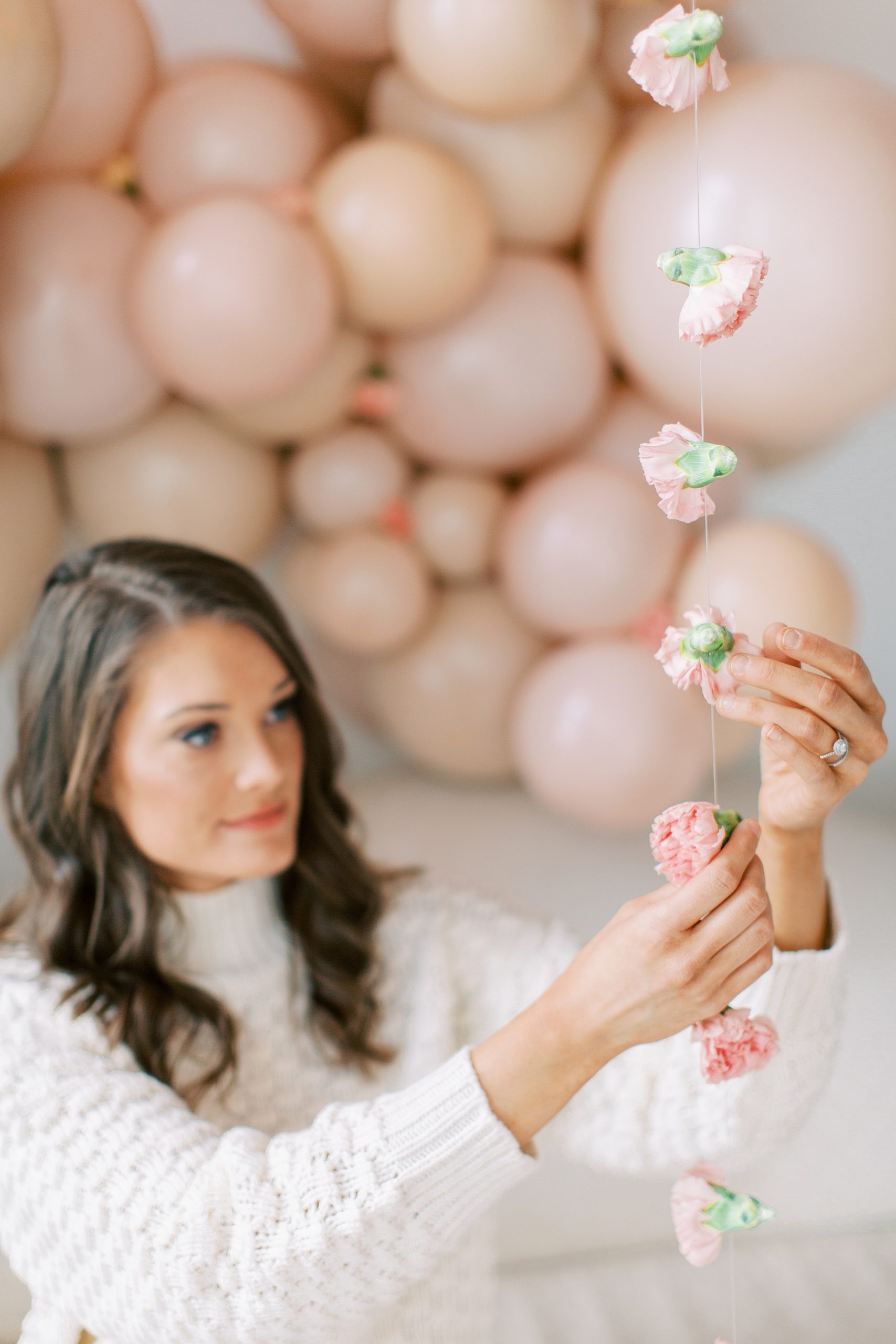 woman looks at floral garland