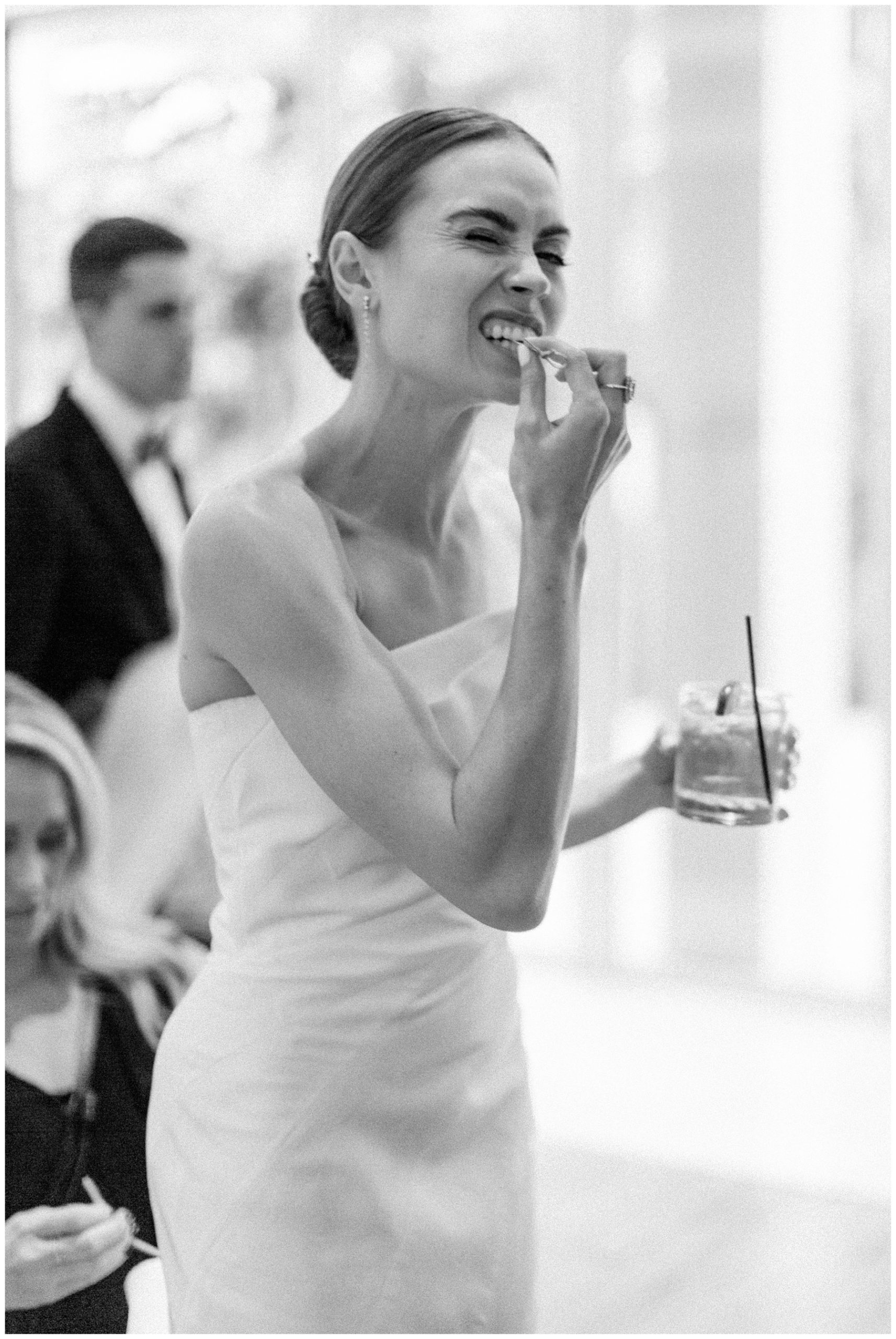 bride bites lemon during wedding reception