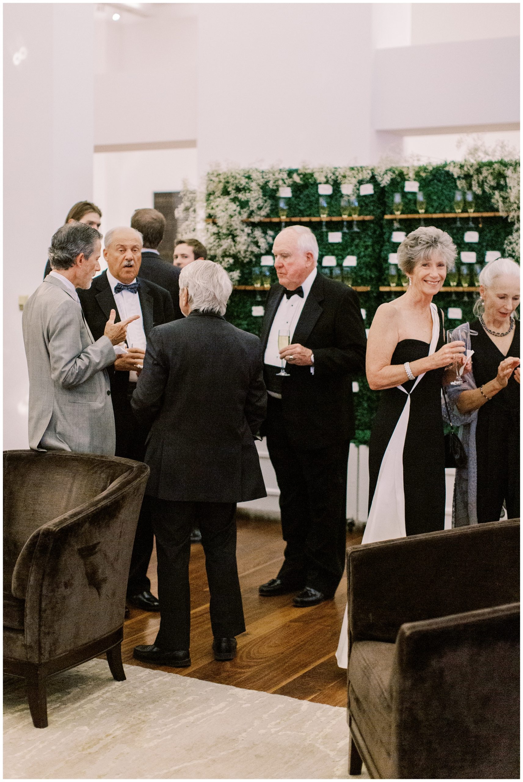 guests mingle by champagne wall at the Foundation for the Carolinas