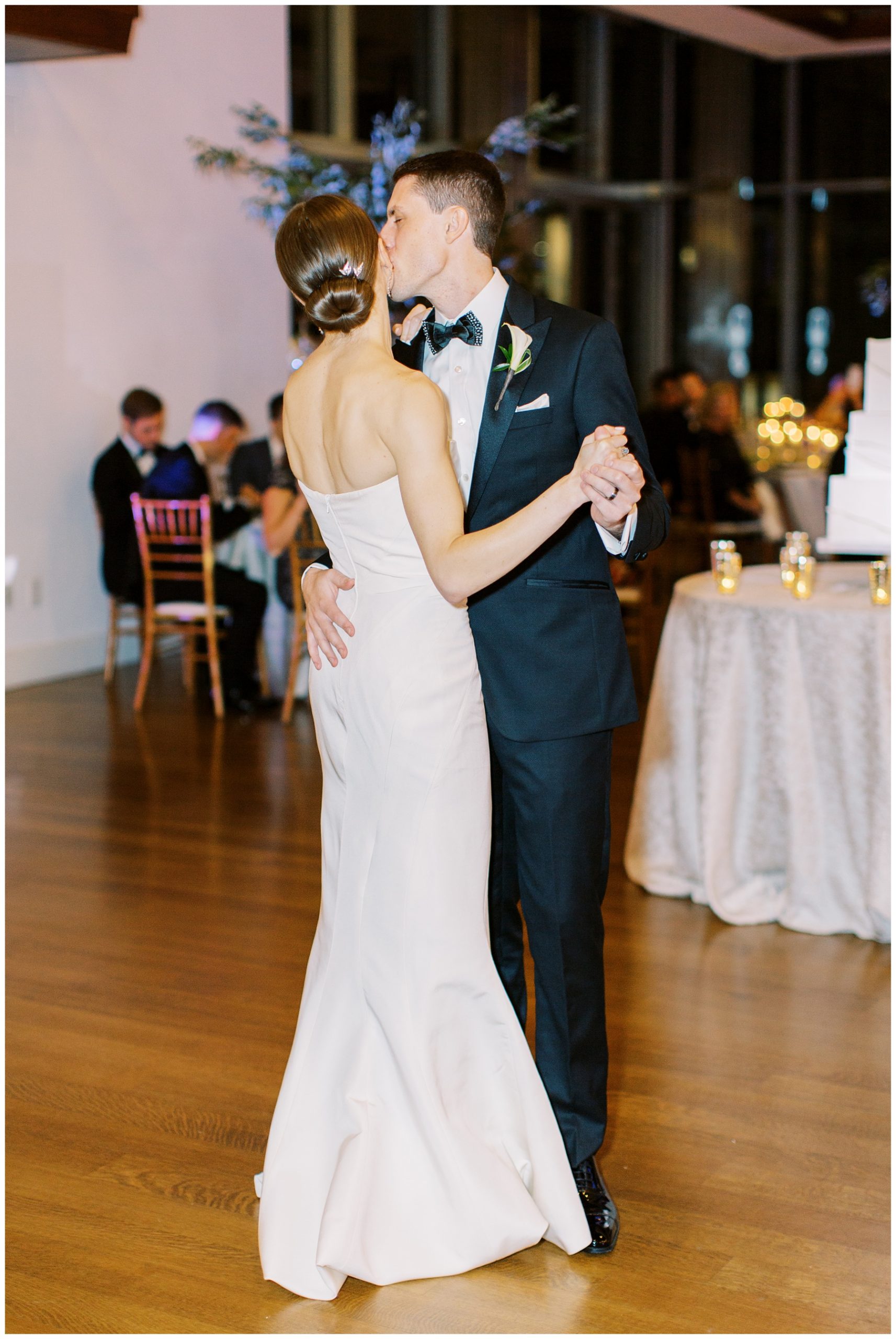 groom kisses bride during wedding reception at Foundation for the Carolinas