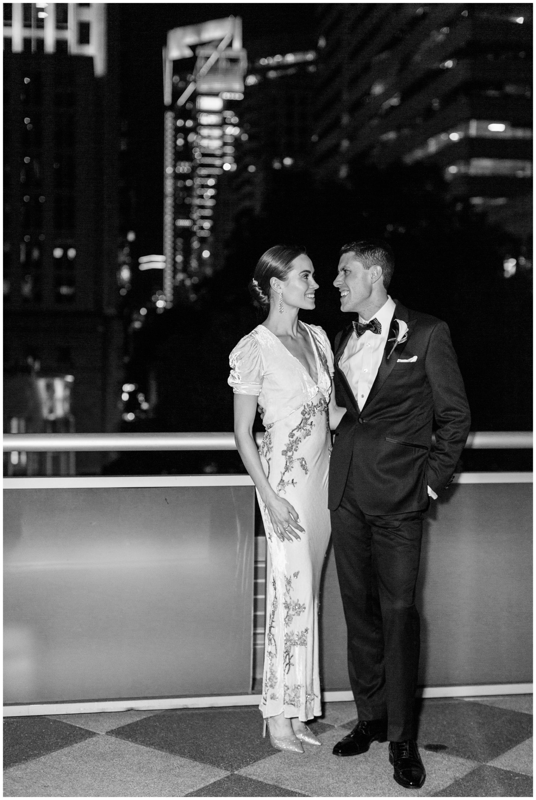 bride in vintage wedding dress and groom pose on balcony at Foundation for the Carolinas