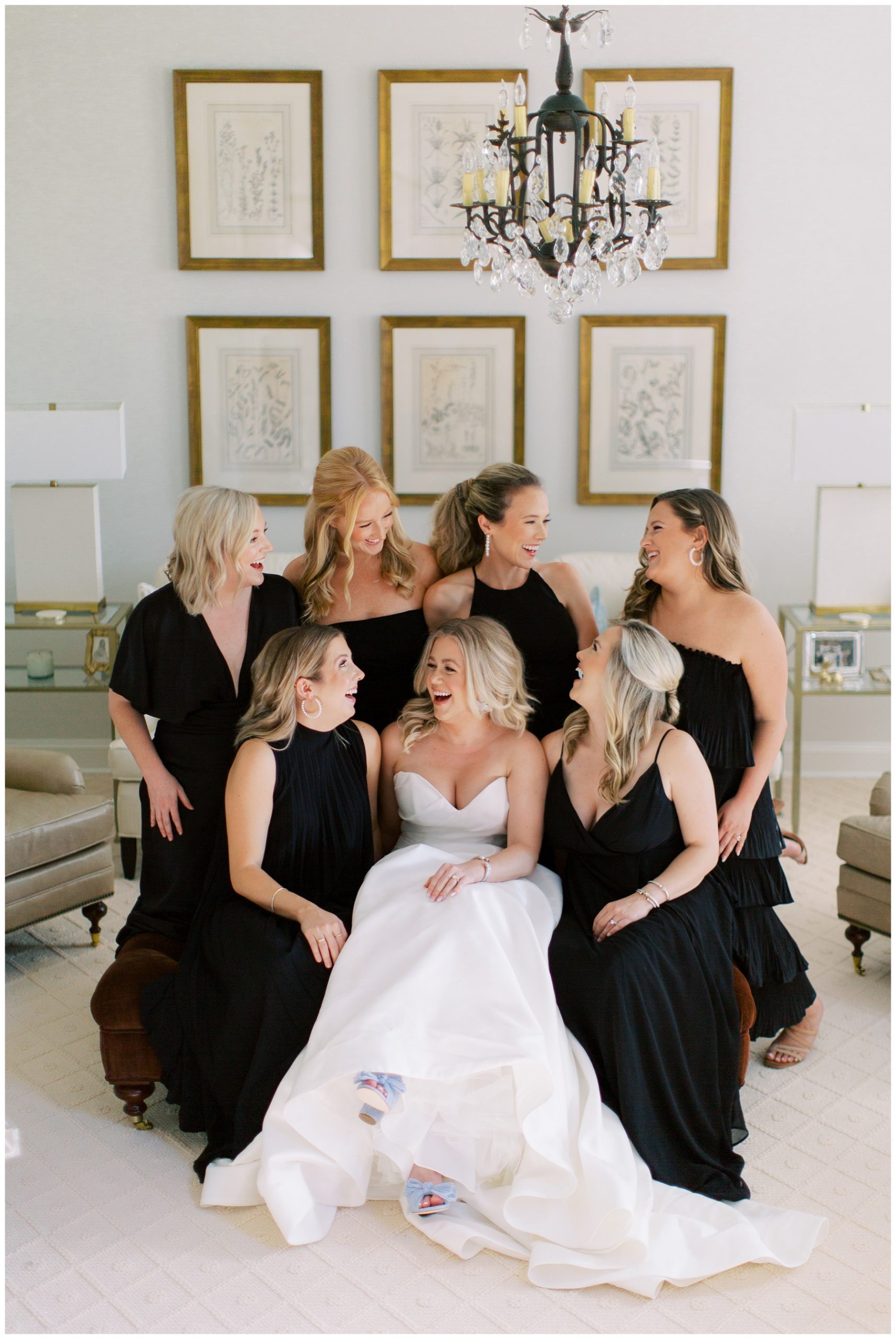 bride laughs with bridesmaids in black gowns in Charlotte NC 