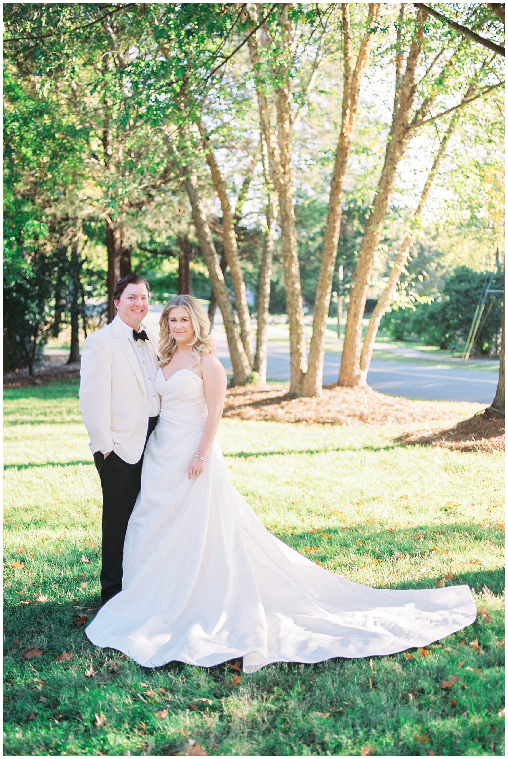 newlyweds pose on lawn at The Terrace at Cedar Hill