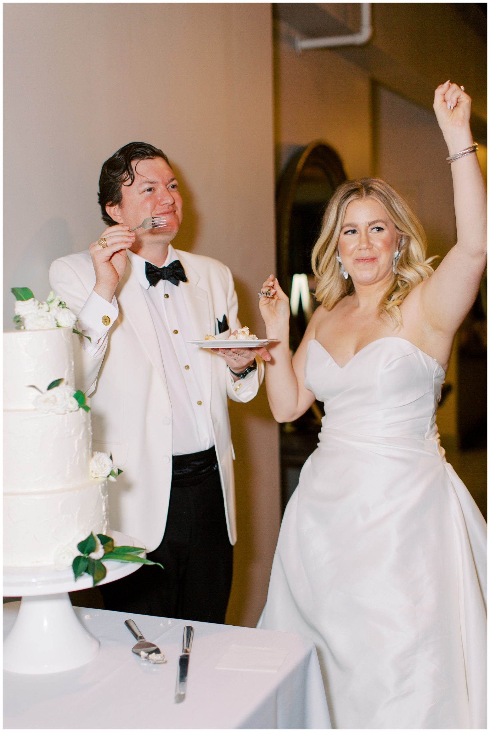 bride and groom cut wedding cake at Charlotte NC reception 