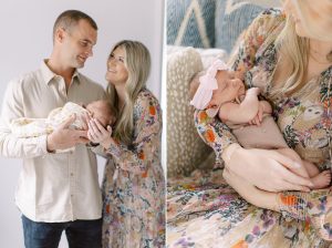 parents smile together holding baby girl during Charlotte newborn session