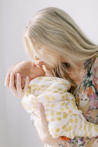 mom kisses baby during photos in Charlotte home