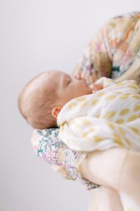mom holds daughter during Charlotte newborn session