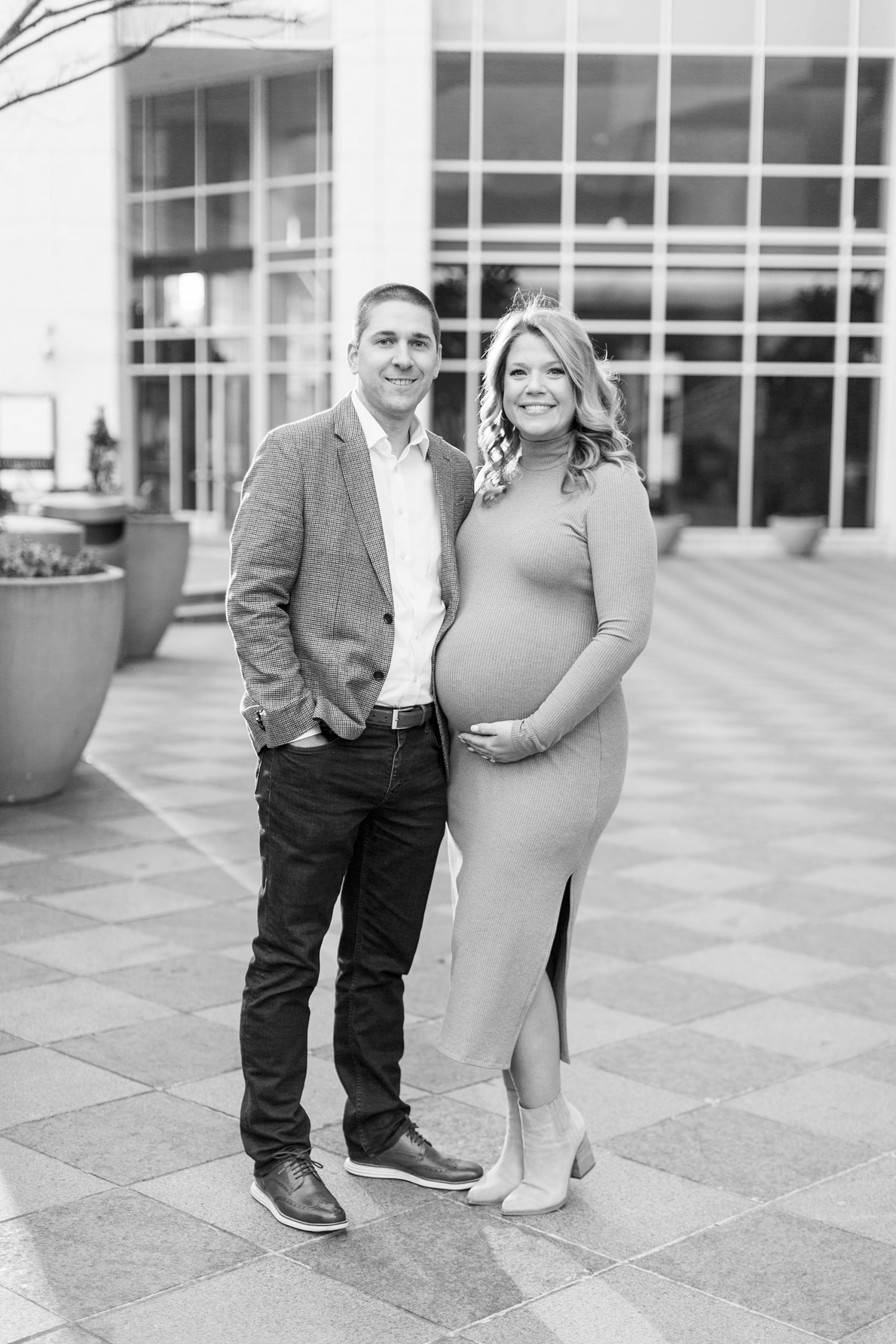 woman holds belly during Uptown Charlotte Maternity Session
