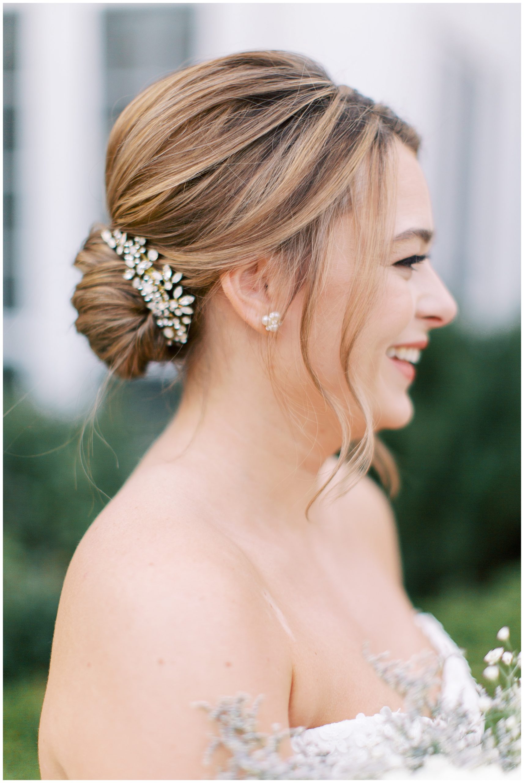 bride laughs showing off classic updo and floral hairpiece for Duke Mansion bridal portraits