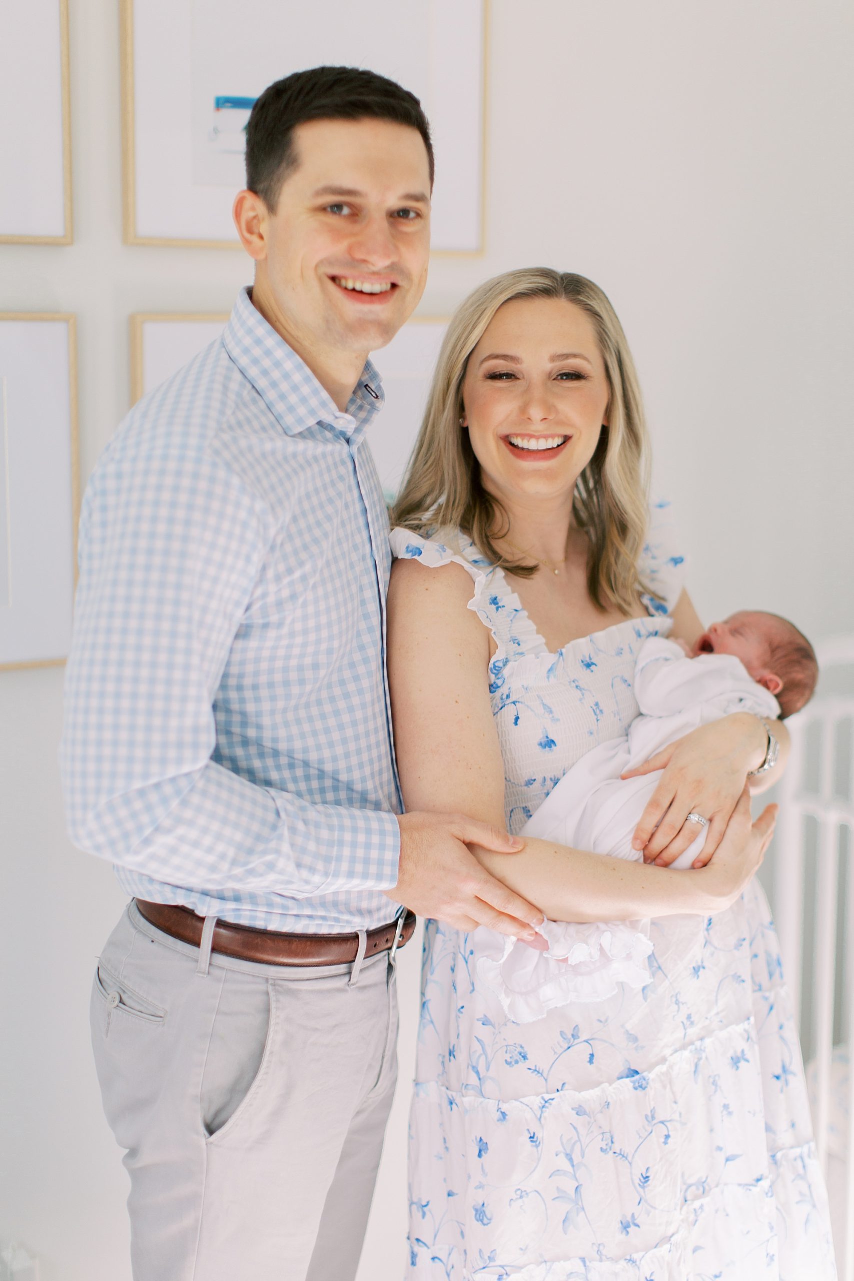 new parents hold son during lifestyle newborn session in Charlotte NC