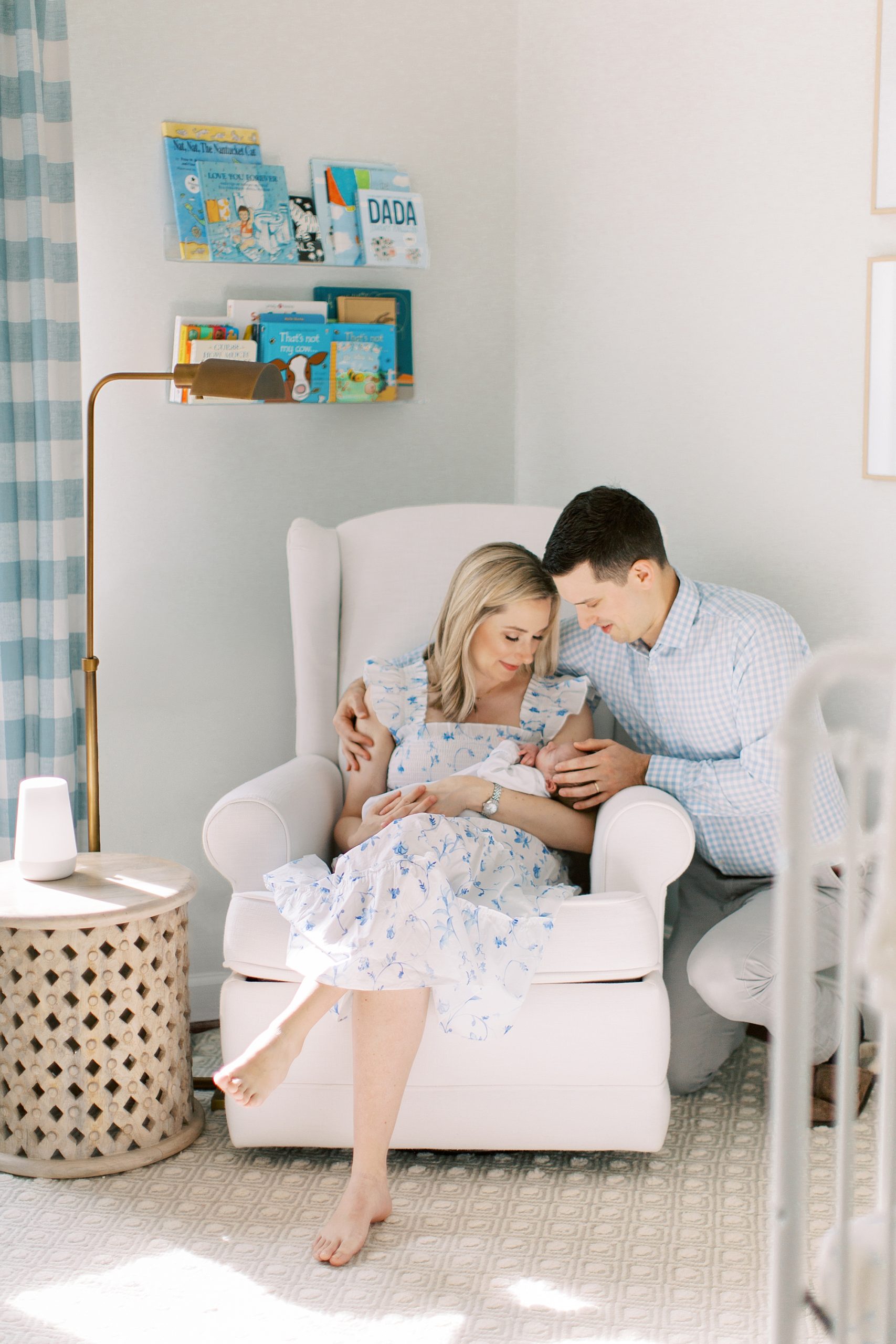 new parents look at son during lifestyle newborn session in nursery