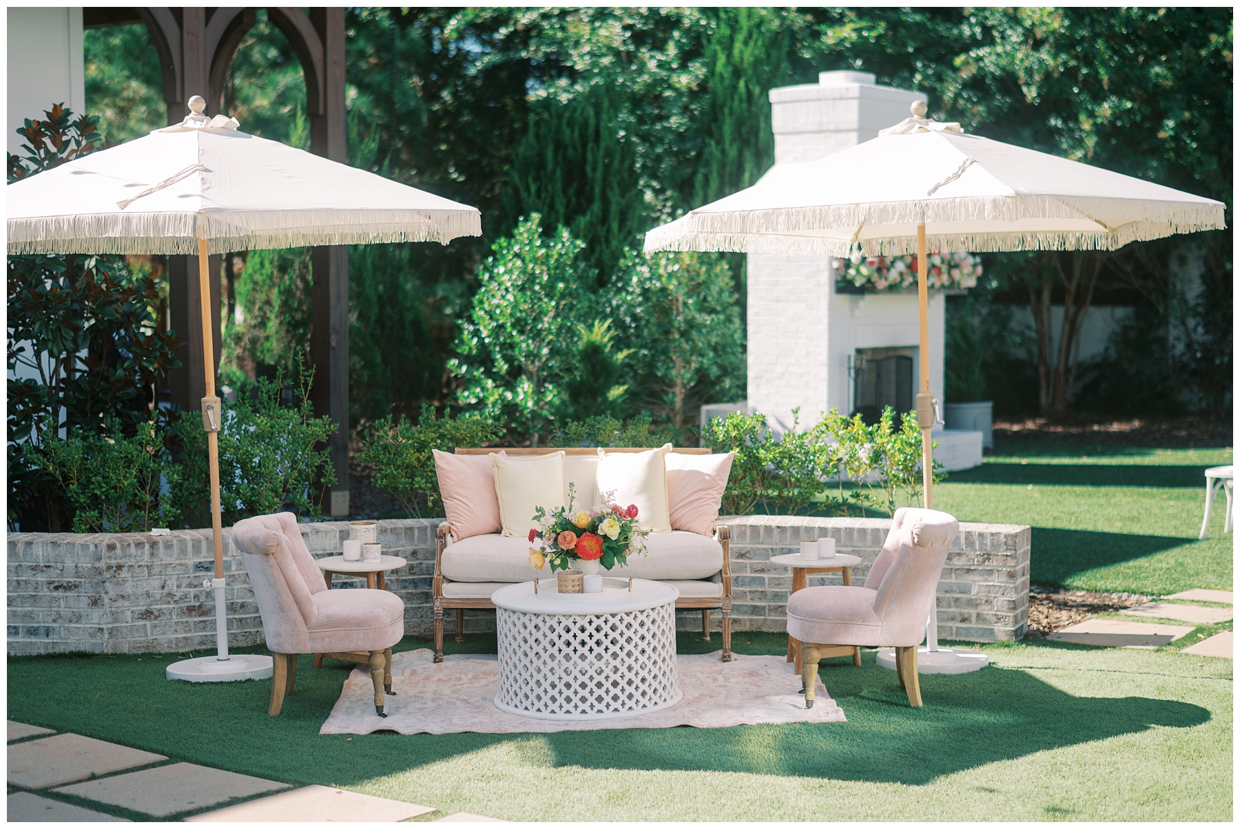 seating area under white umbrellas with bright floral centerpiece at The Bradford