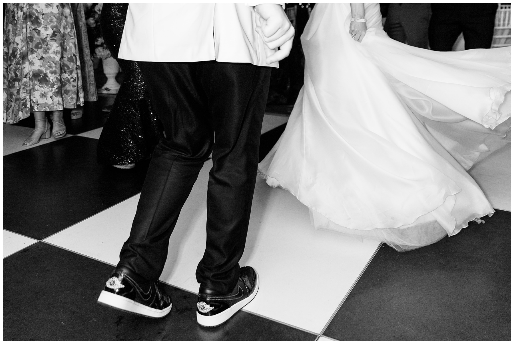 bride and groom dance on black and white tiled floor during South Carolina wedding reception 