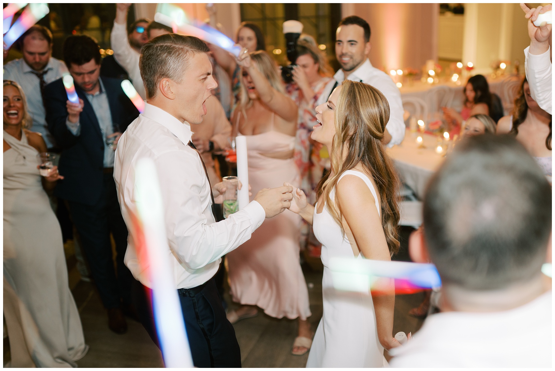 bride and groom sing to each other dancing with guests at outside reception at The Bradford