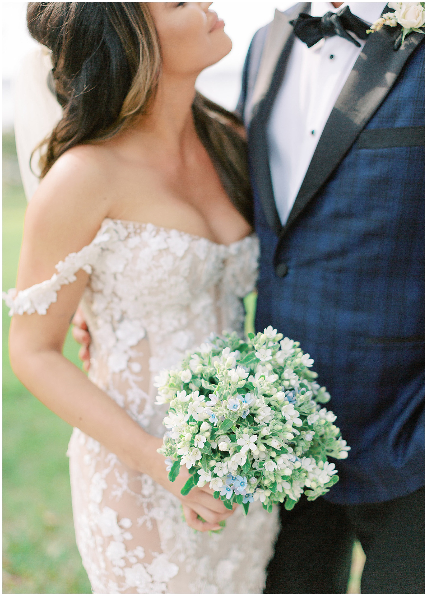 bride holds bouquet of white and blue flowers for spring wedding at Lowndes Grove