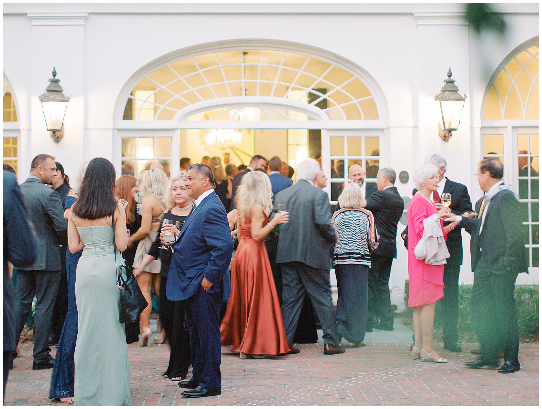 guests mingle outside Lowndes Grove during cocktail hour in Charleston SC