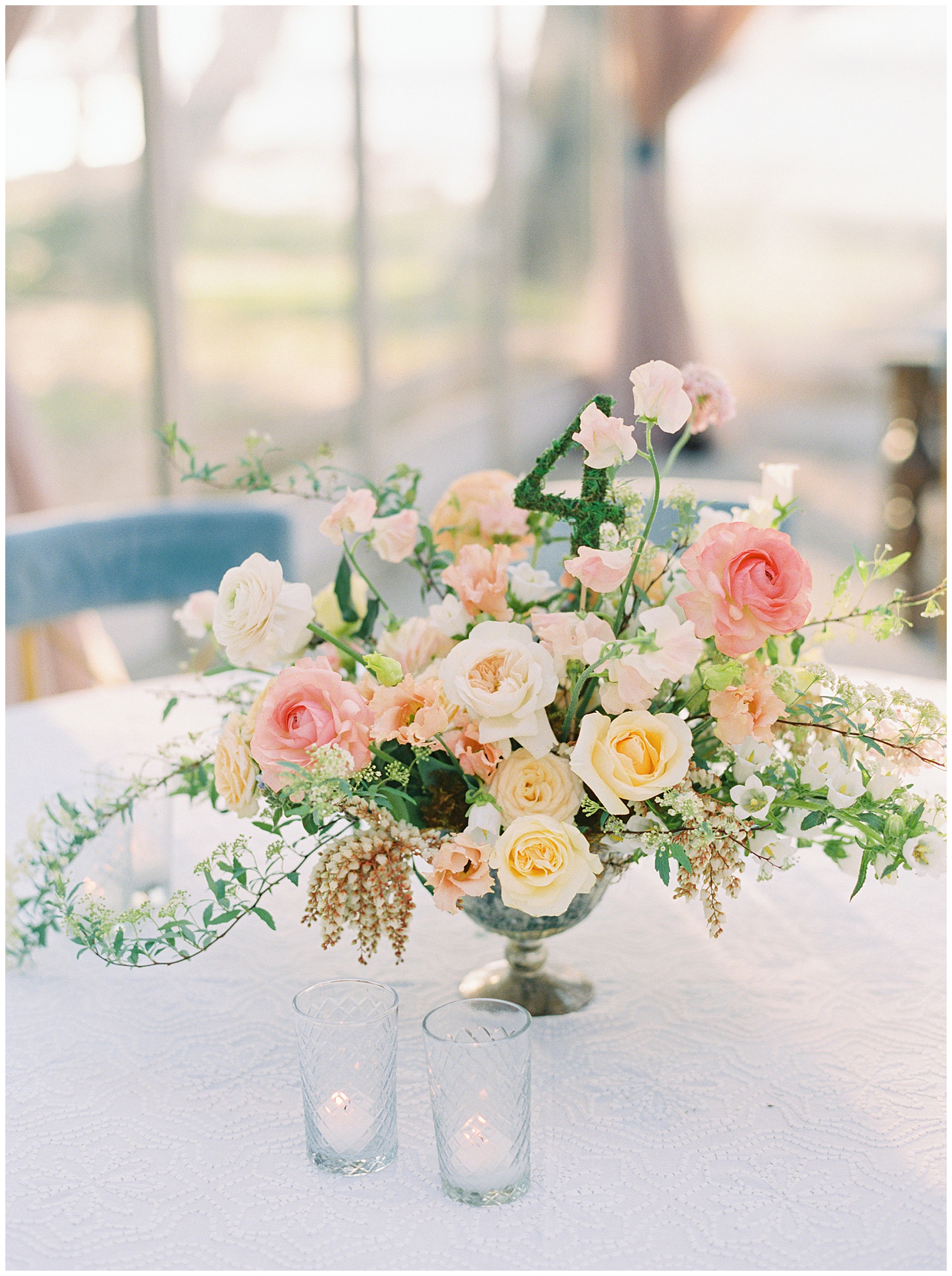 centerpiece with peach, pink, and white flowers for springtime Lowndes Grove wedding