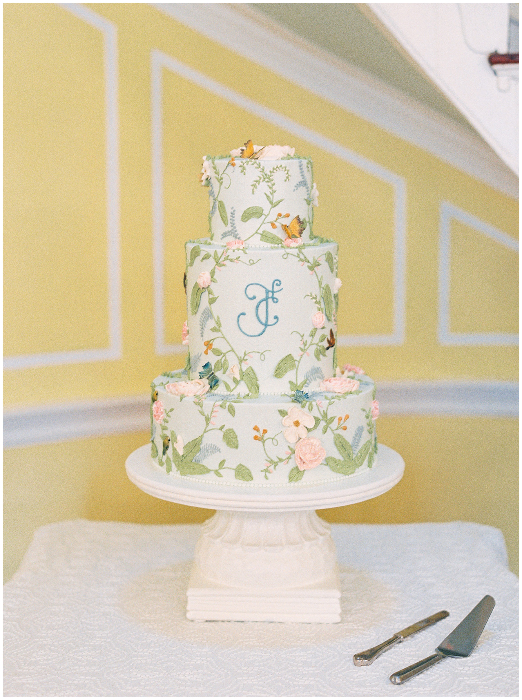 pastel floral Bridgerton inspired wedding cake on white cake stand for Charleston wedding 