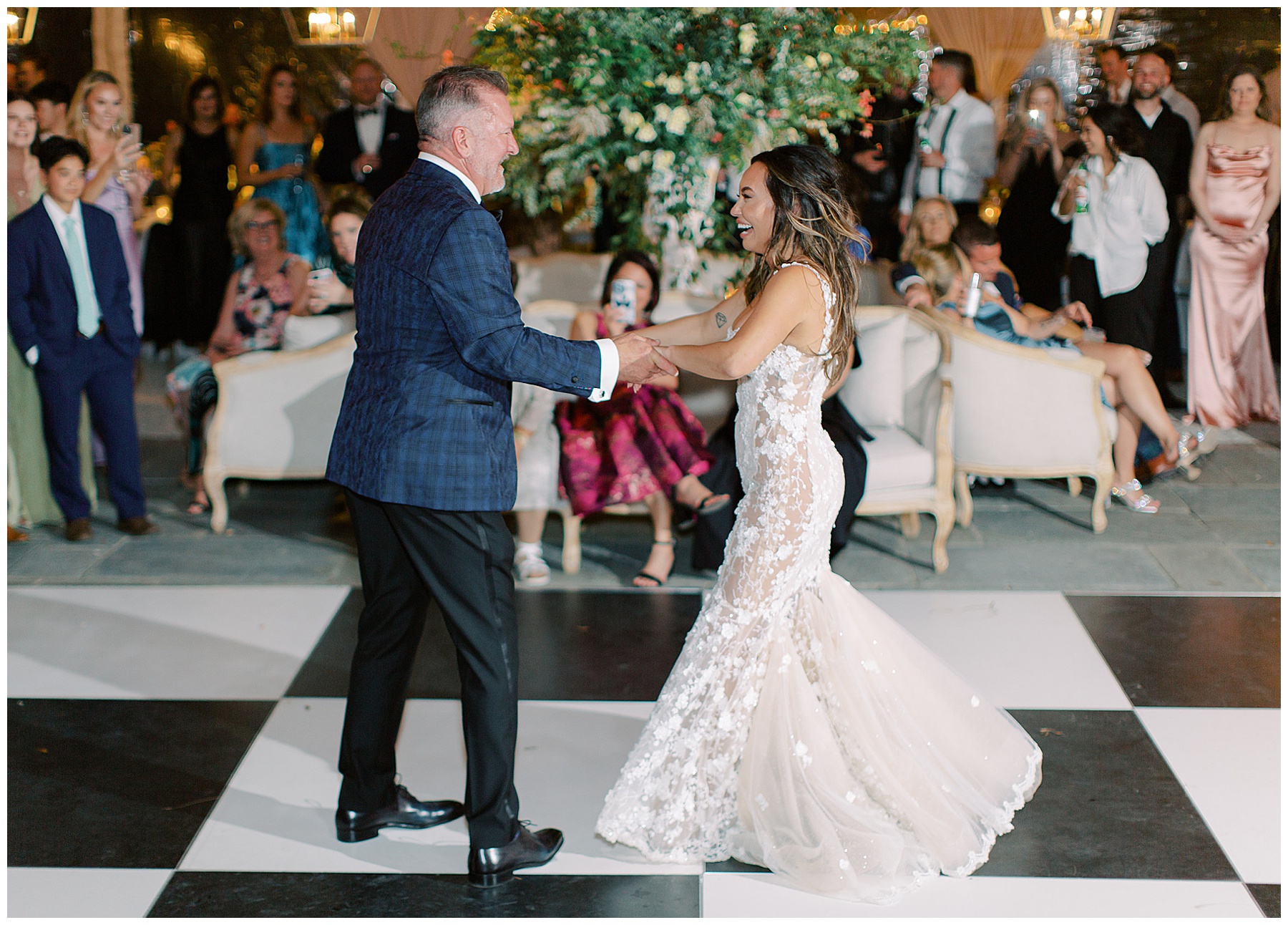 groom twirls bride on black and white dance floor during Charleston wedding reception at Lowndes Grove