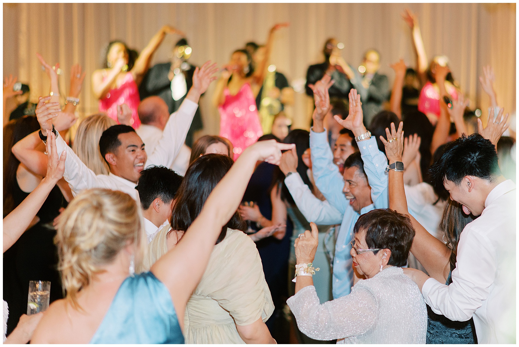 guests dance during Charleston wedding reception to live band in background 