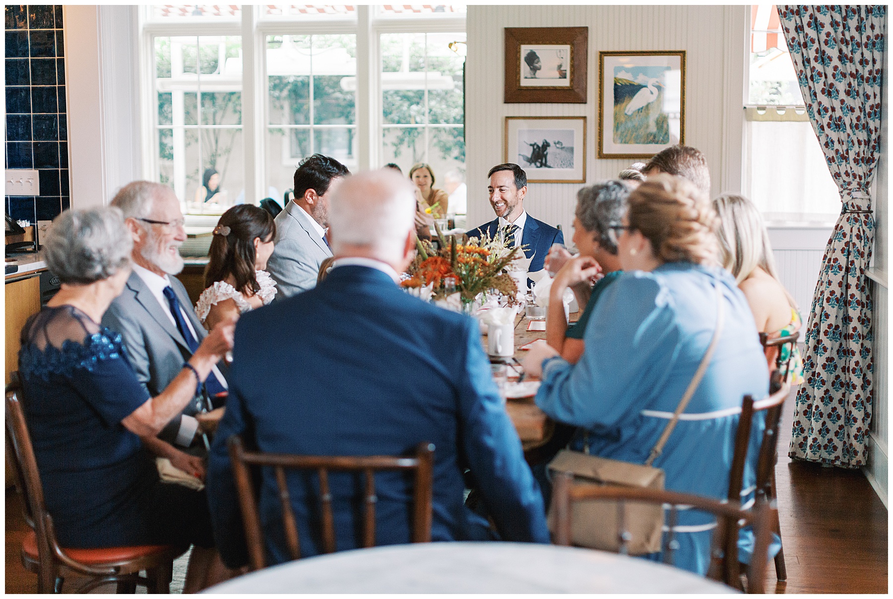 bride and groom sit with wedding guests during brunch after wedding at the Post House Inn