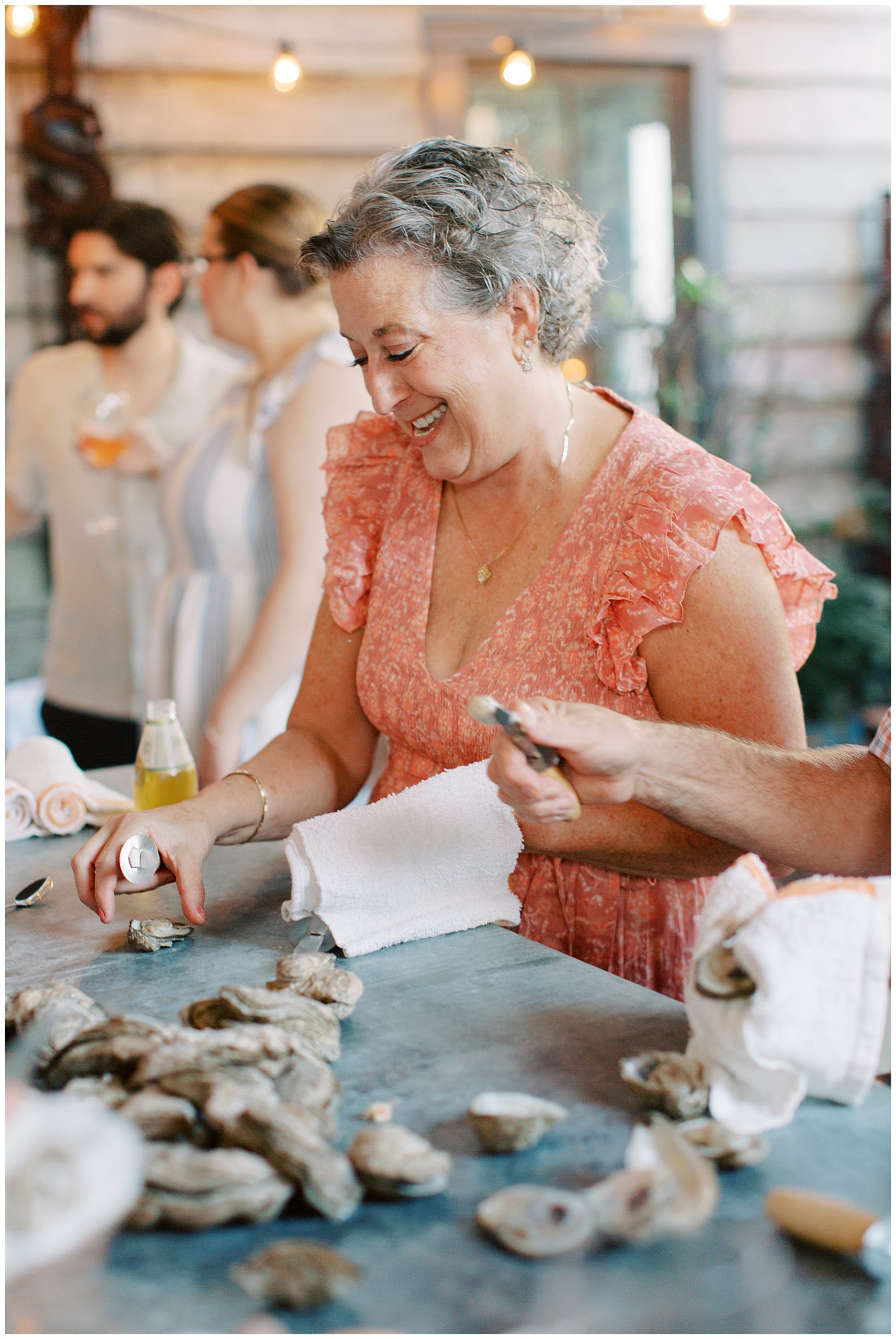 guests shuck oysters during reception party at Leon's Poultry & Oysters